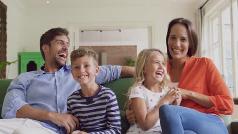 family playing together on sofa in living room at home 4k