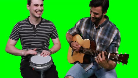 Male-musicians-playing-guitar-and-drum