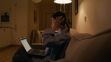 woman working from home at night on laptop