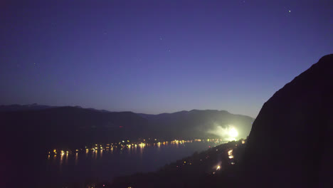 Wide-shot-looking-down-at-fireworks-lighting-up-the-night-sky-over-donner-lake-in-Truckee-California-during-the-4th-of-July-celebration