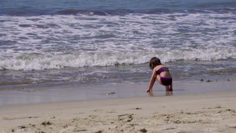 a girl plays and enjoys a sunny day at a mexican beach