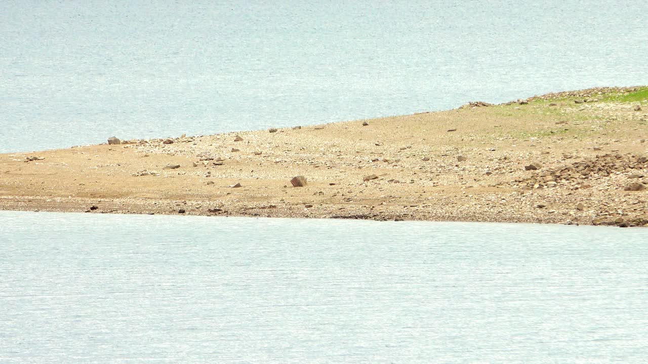 Bar of shore between two bodies of water.