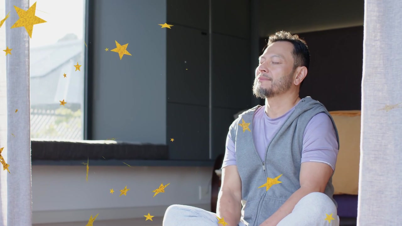 Vertical video: Meditating man in purple tee uncrossing at door as gold stars appear, phone nearby
