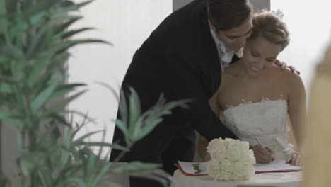 happy groom signing documents