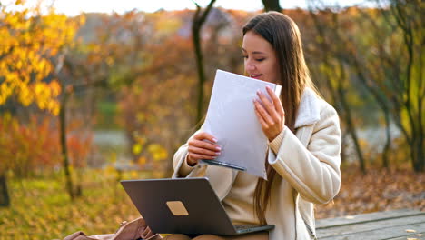 woman working outdoors in autumn park