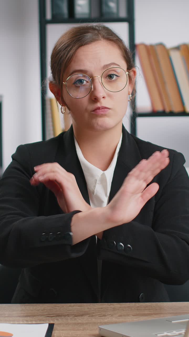 Businesswoman working on laptop showing stop gestuge danger rejection warning crisis prohibition