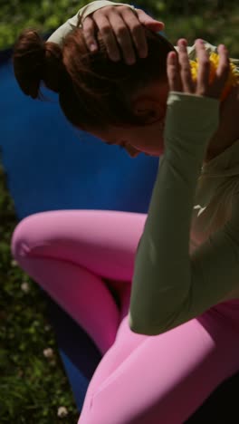 woman stretching and massaging neck and shoulders