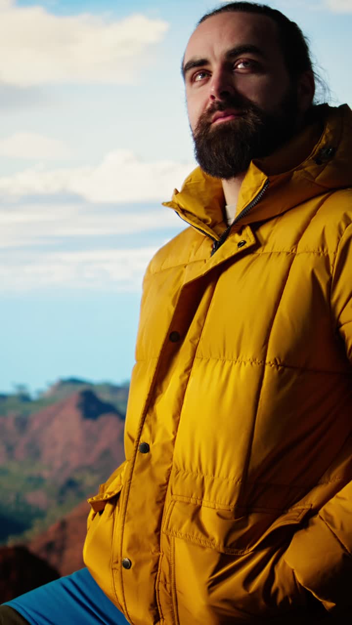 Man in Yellow Puffer Jacket Enjoying Mountain View