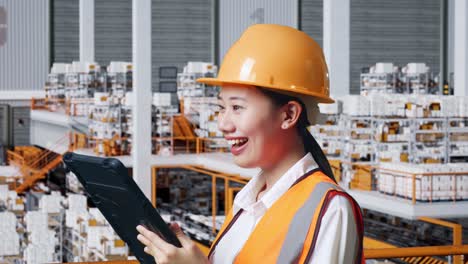 female engineer using tablet in warehouse