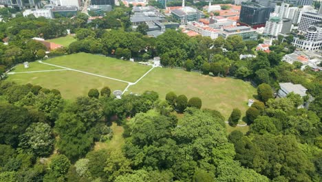 Aerial-perspective-over-Singapore's-Fort-Canning-Park,-green-oasis-in-the-city