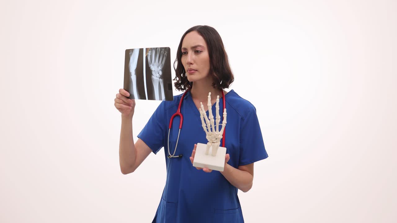 Medical Professional Examining X-ray with Hand Model