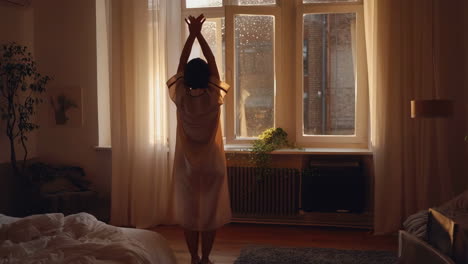 woman stretching in bedroom in the morning