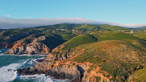 aerial view green hills landscape stormy sea crashing rocky shoreline summer