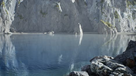 sand beach among rocks at atlantic ocean coast in portugal