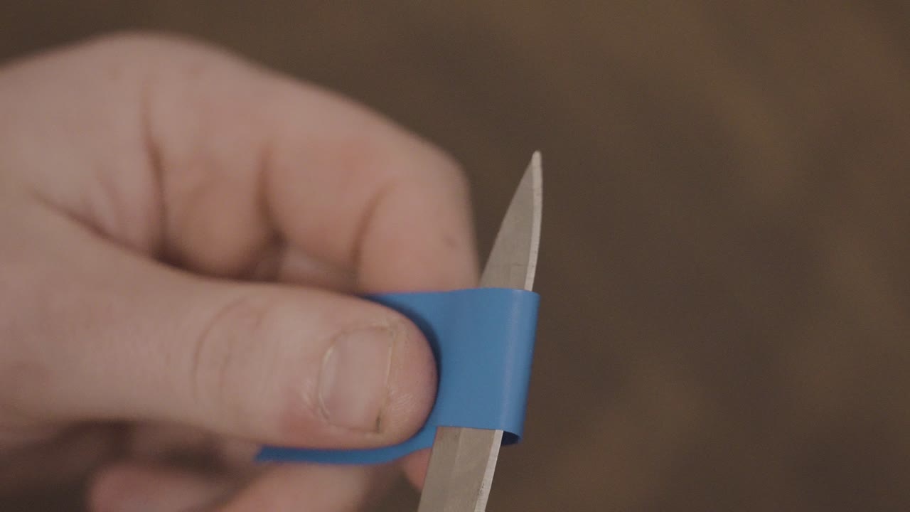 Cutting a small piece of electric tape.