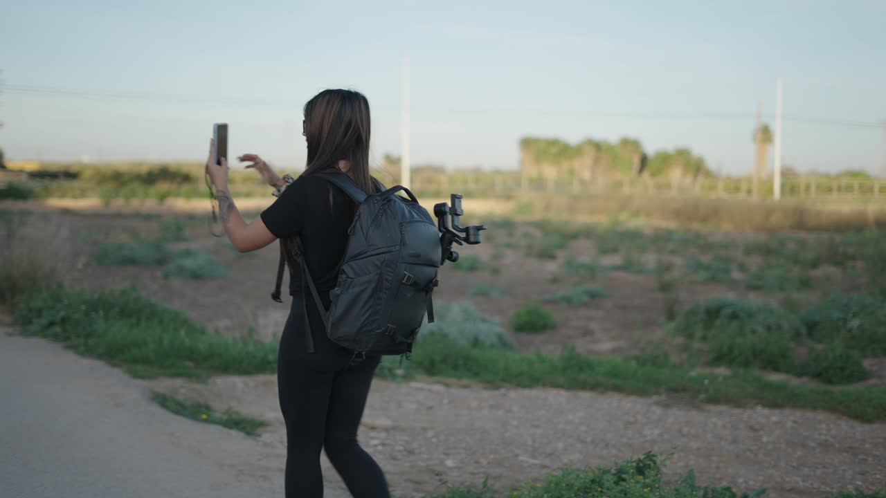 Woman taking a selfie in a field