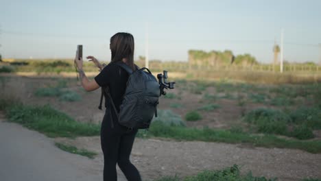 woman taking a selfie in a field