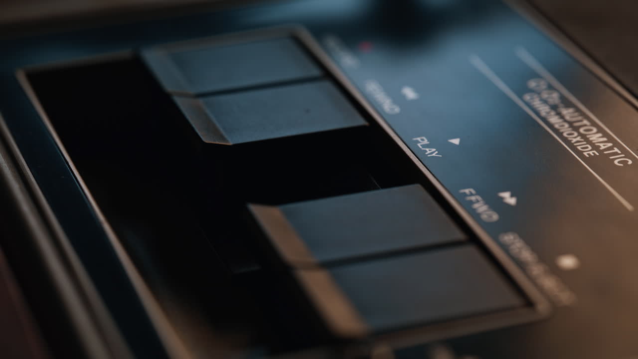 Closeup finger pushing play button on panel retro audio player. Oldschool style