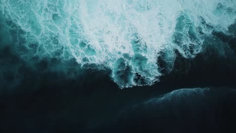 aerial view of a big wave crashing onto the rough seas found on the north shore of oahu, hawaii