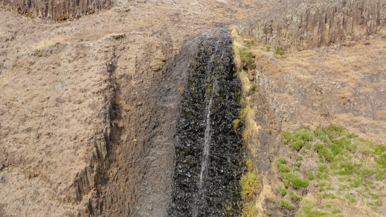 Rising aerial over small waterfall, almost dried out, dry summer season, Tabletop Mountain