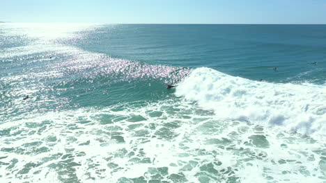 4k Aerial shot of a man bodysurfing on a big wave with his bodyboard in Australia.