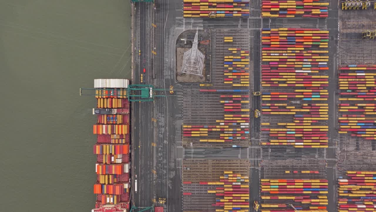 Antwerp container terminal from above, cranes unloading cargo ships, Belgium