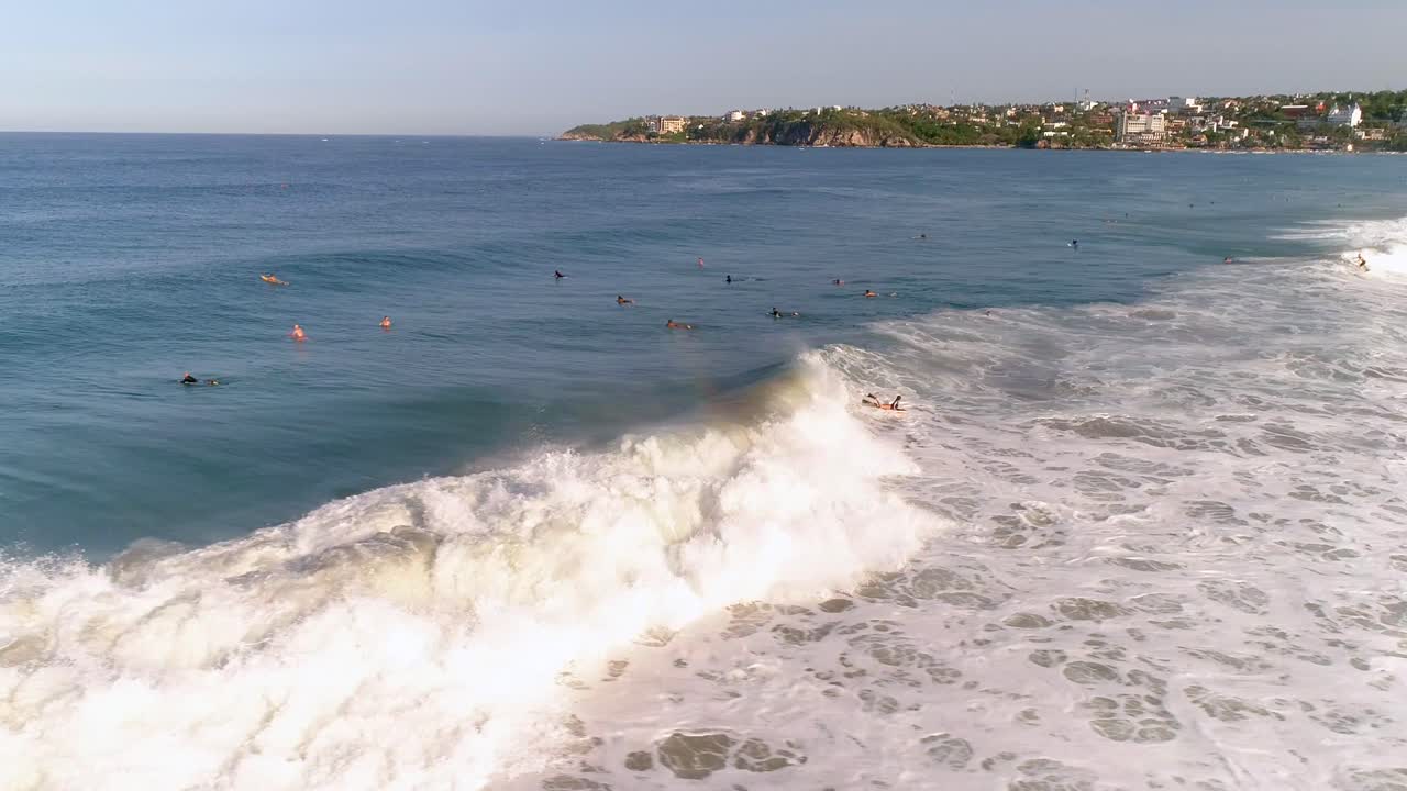 toma aérea de un boogie boarder en una ola de tubo grande con un arco iris en la playa de zicatela puerto escondido, oaxaca