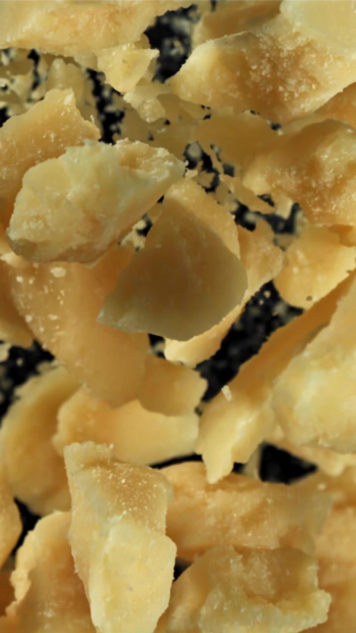 Slow Motion Close Up of Grated Parmesan Cheese Falling