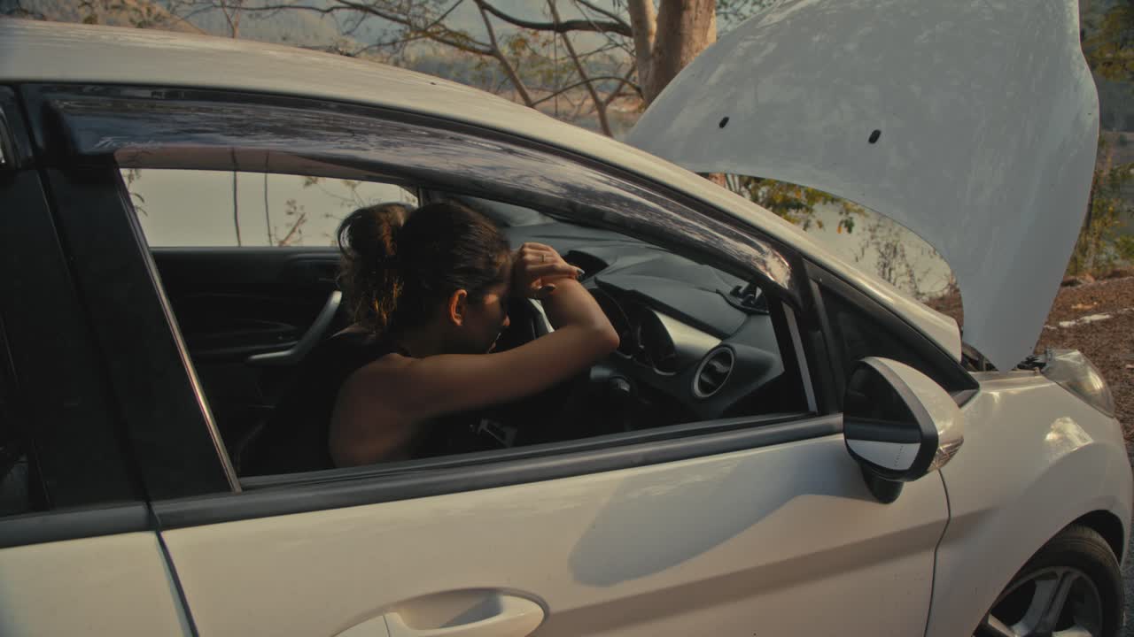 Woman with a broken down car