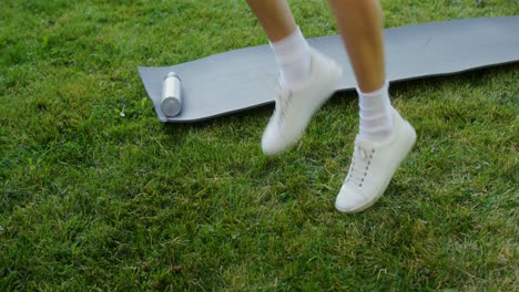 person jumping jacks outdoors