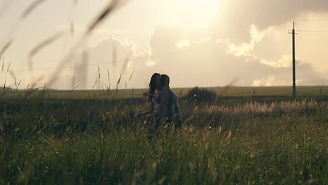 muscular dancing man silhouette lifts young girl and spins