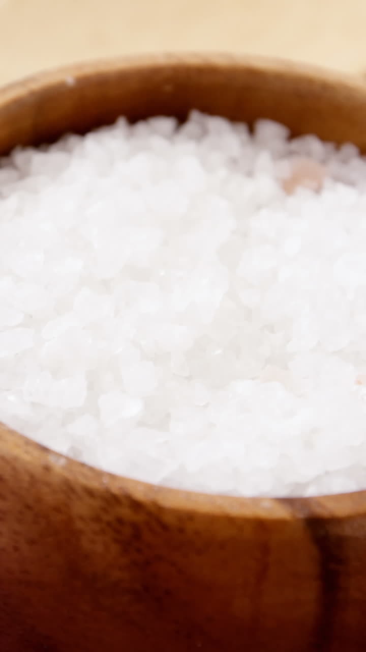 Sea salt in wooden bowl and wooden spoon