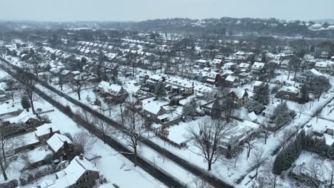 Aerial-establishing-shot-of-a-snowy-suburb