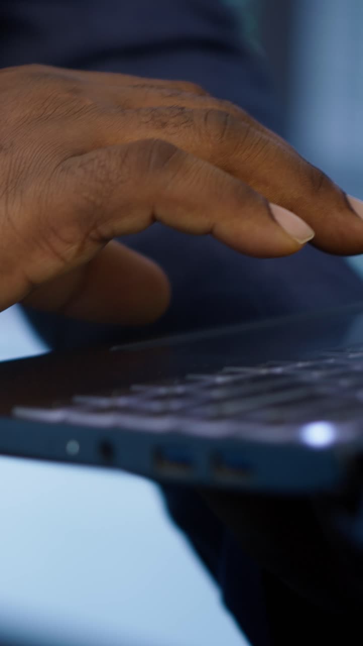 Close-up of Hand Using Laptop Touchpad and Keyboard