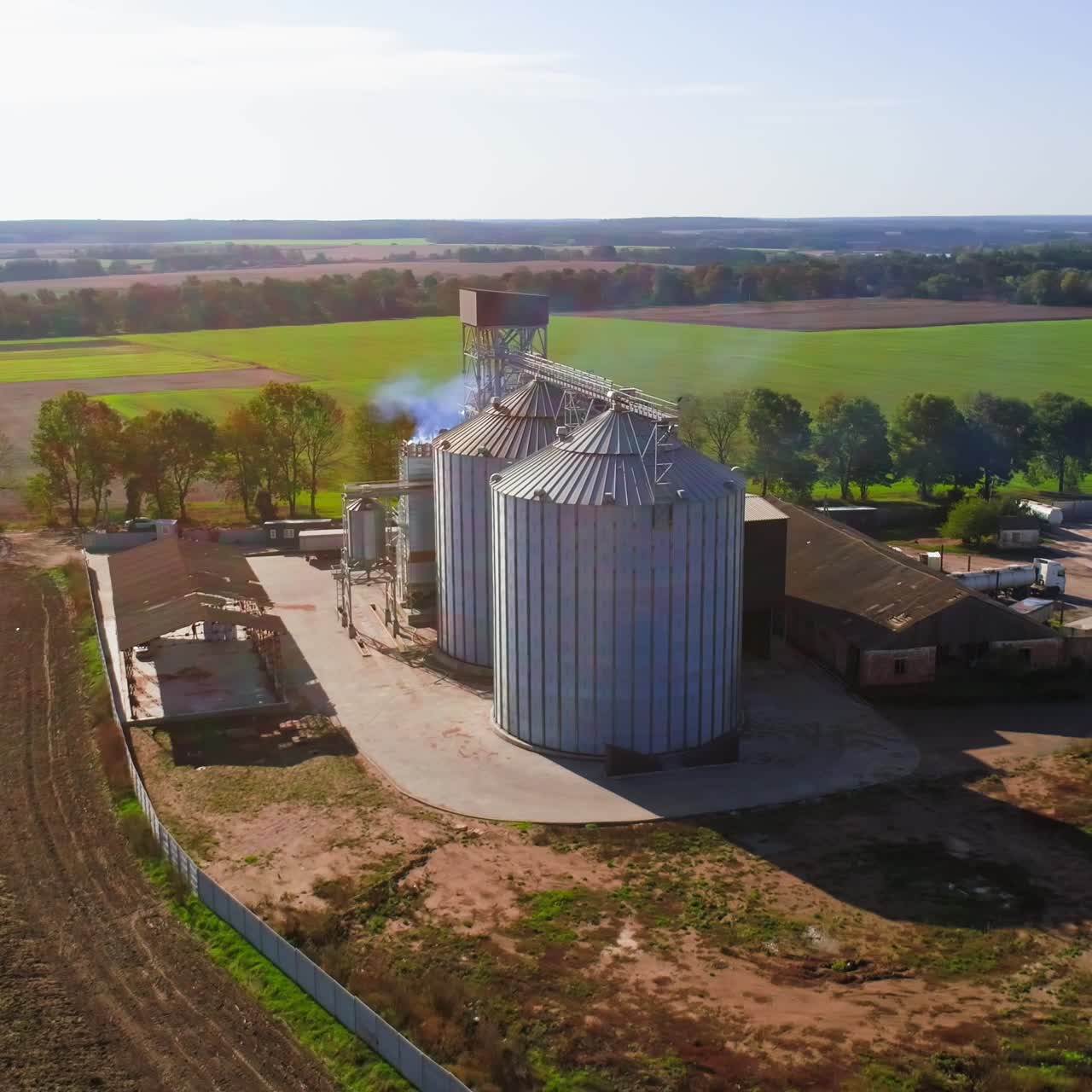 Aerial view. Metal grain elevator in agricultural zone. Grain warehouse