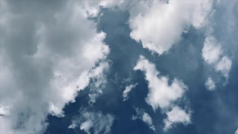 grayish white clouds moving softly in sunny blue sky