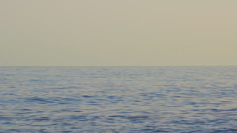 ocean waves with blurred background and clear sky after sundown