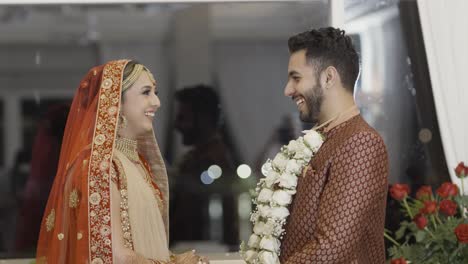 jayamala ritual - indian bride puts on garland to groom during hindu wedding ceremony