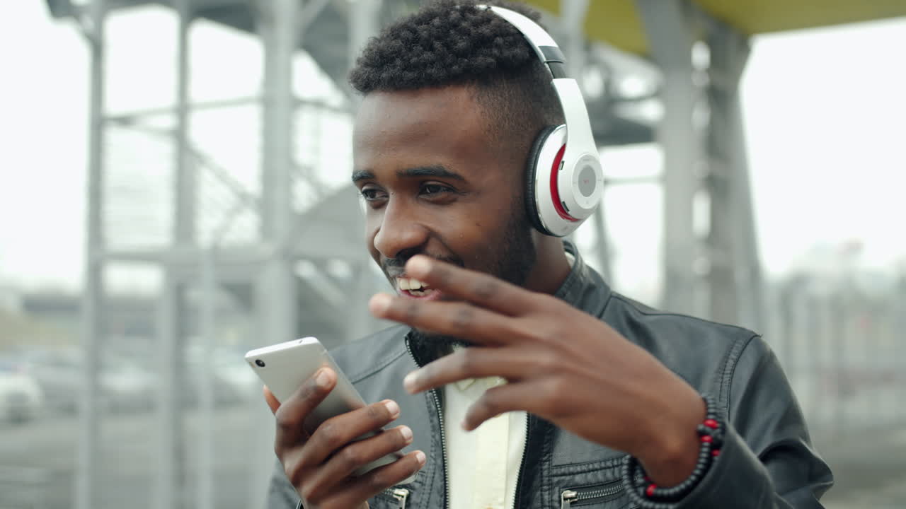 Man enjoying music on his phone outdoors