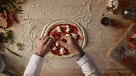 pizza cook making food on kitchen table. chef hands prepare recipe in restaurant