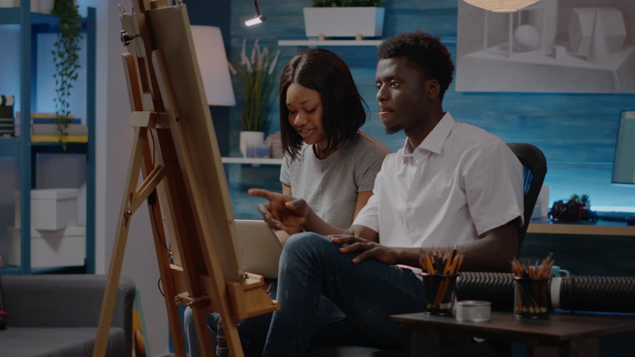 Couple of african american artists creating art drawing design