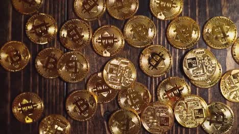 cinematic video of cryptocurrency bitcoin coins on a wooden table lit beautifully