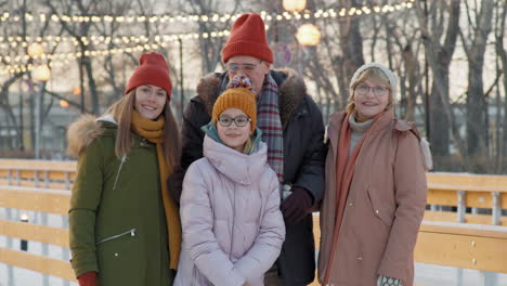 family portrait at an ice skating rink in winter