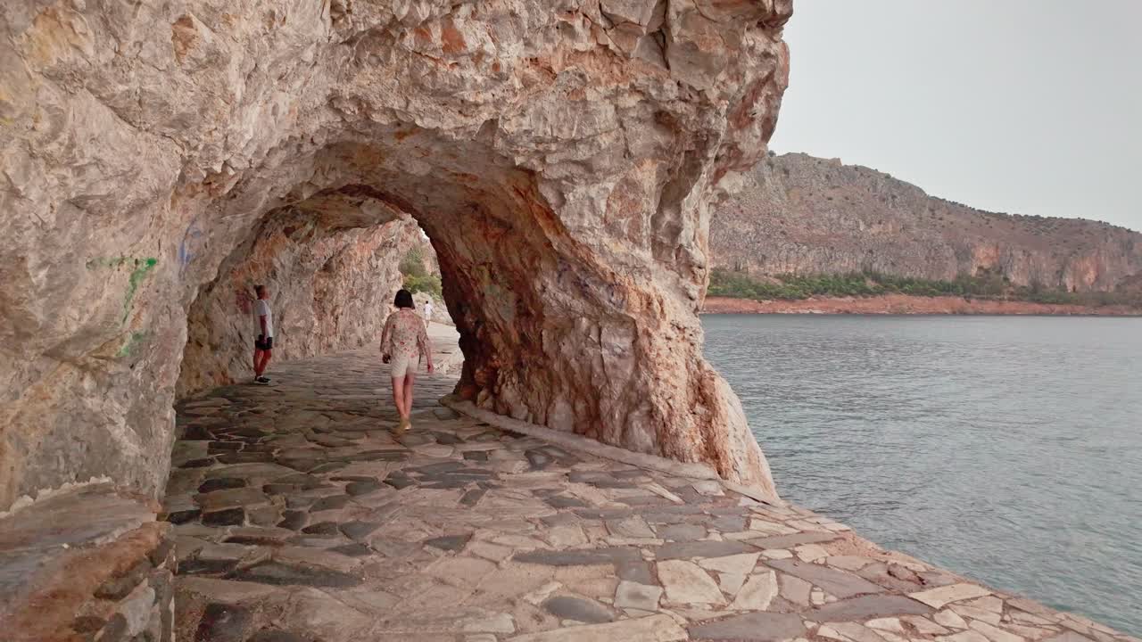 Coastal footpath rock archway on Nafplion Acronauplia promenade