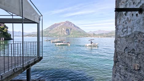 sailboats on lake como with mountain backdrop