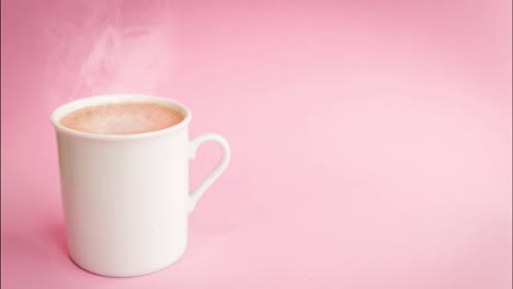 white cup of coffee on light pink  background