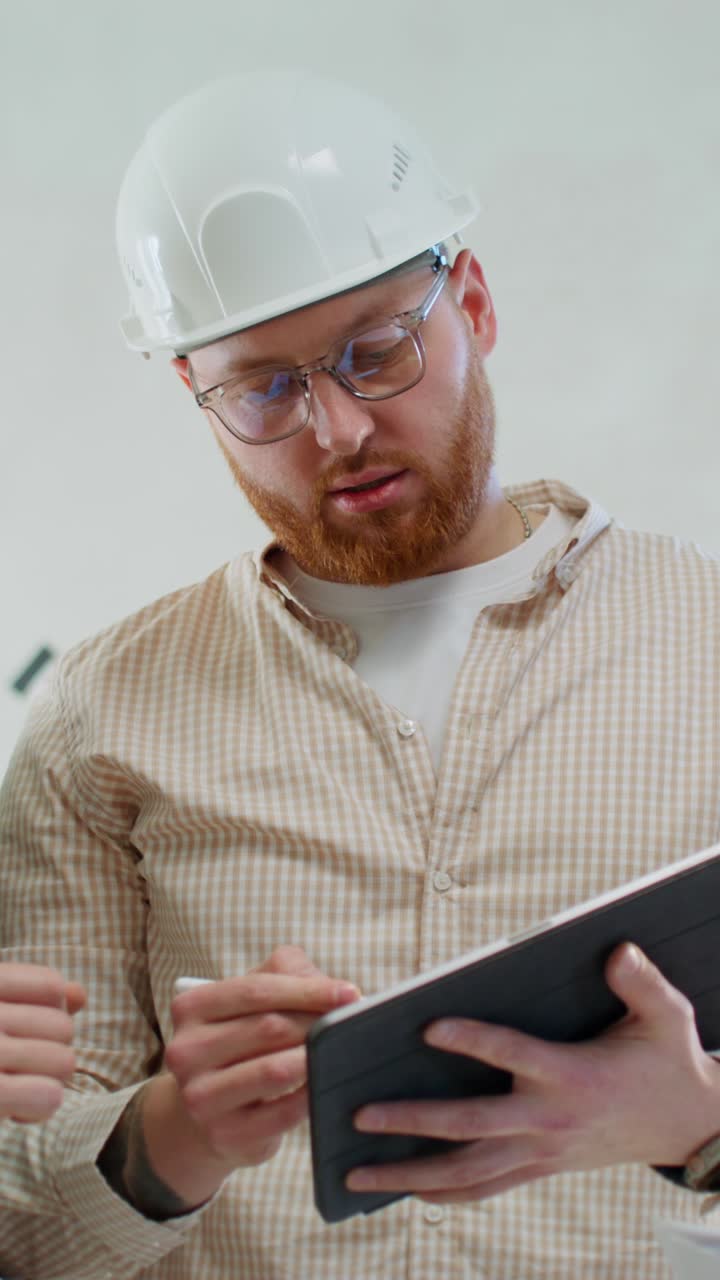 Engineers Discussing Project on Tablet