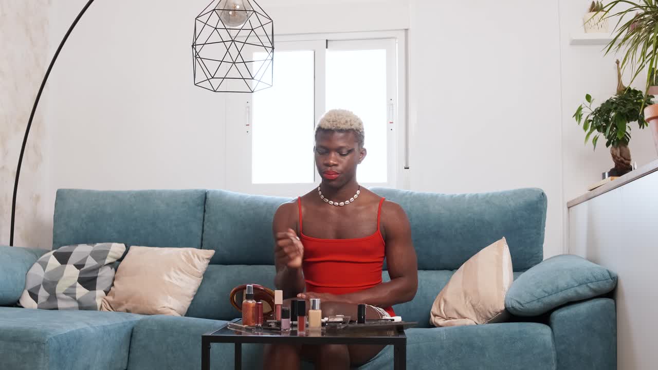 Person applying makeup on a couch in a living room