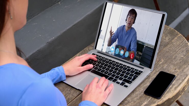 Caucasian woman using laptop on video call with male colleague working from home