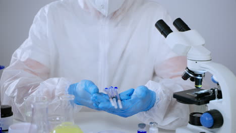 scientist holding syringes in a laboratory